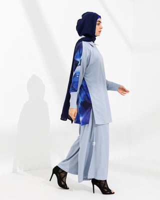 Back view of Shehna Hussain’s Nour coord set featuring deep blue silk digital art print inspired by Rumi. Styled with navy hijab and bamboo backdrop.
