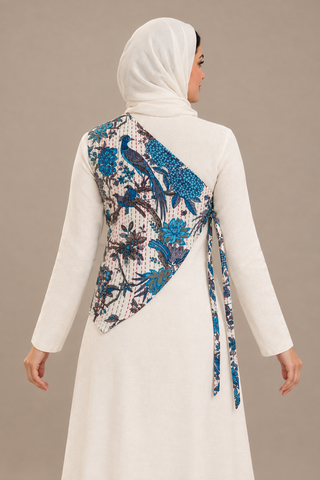 Evolving one-shoulder tie waistcoat, model back and side view showing diagonal cut, blue print and side ties; AI-styled visualization