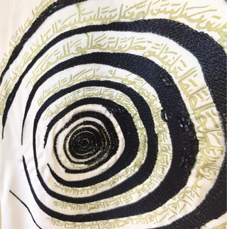 Close-up of the hand embroidery — black bugle beads and gold Arabic calligraphy, stitched by hand