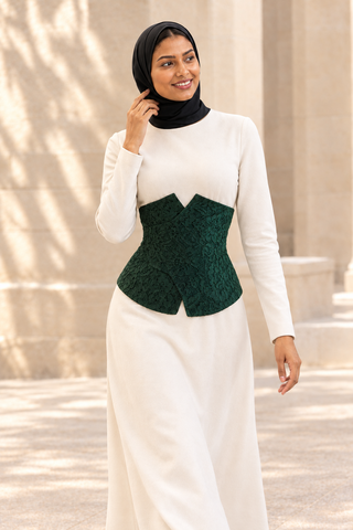 Wasl Green Lace Corset Belt, front view on model over a plain ivory dress. Digitally styled.